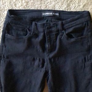 Black mid-rise skinny jeans.